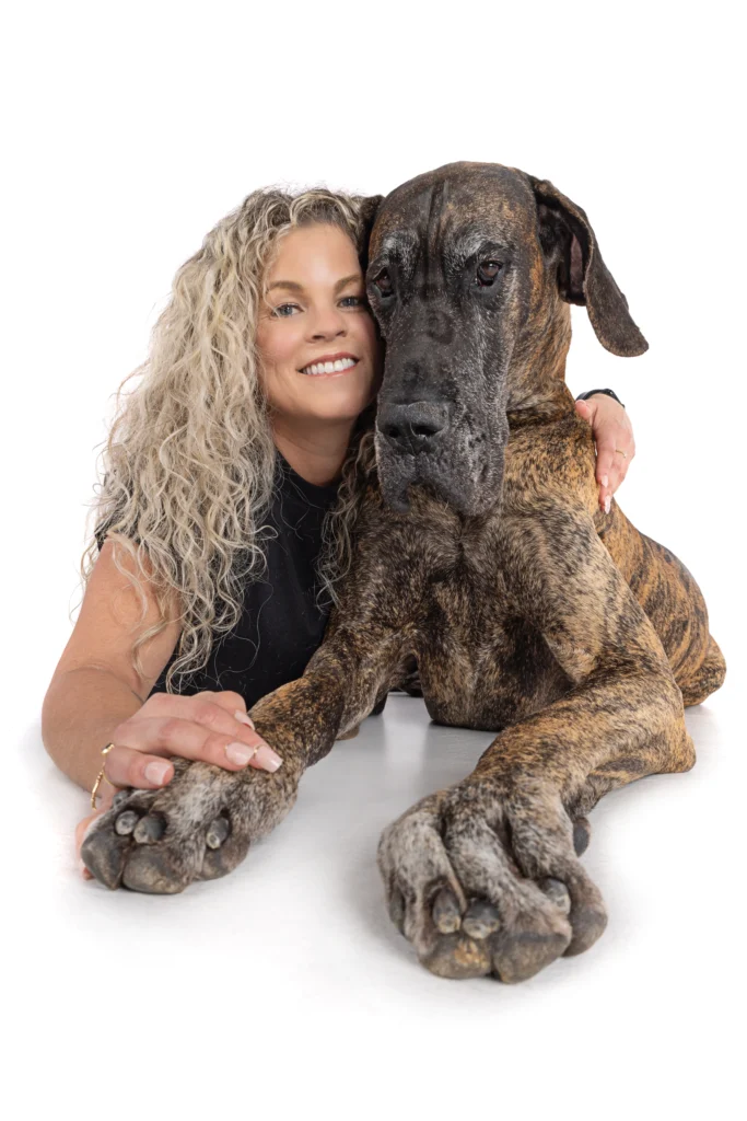Fullerton therapist Keri Prather, LMFT, smiling with her canine therapy companion, Great Dane Anders.