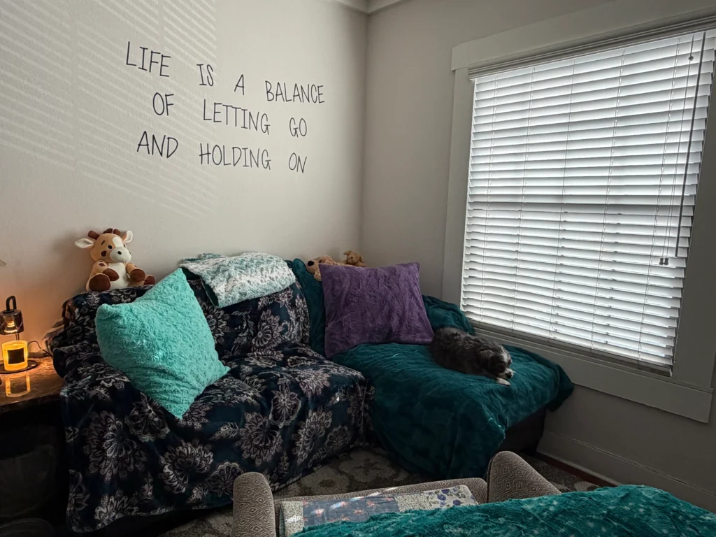 Cozy in-person therapy room at Keri Prather Therapy in Fullerton, CA, featuring a comfortable counseling couch.